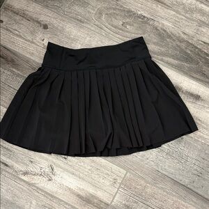 Athleta black pleated tennis skirt with built in shorts with pocket size small